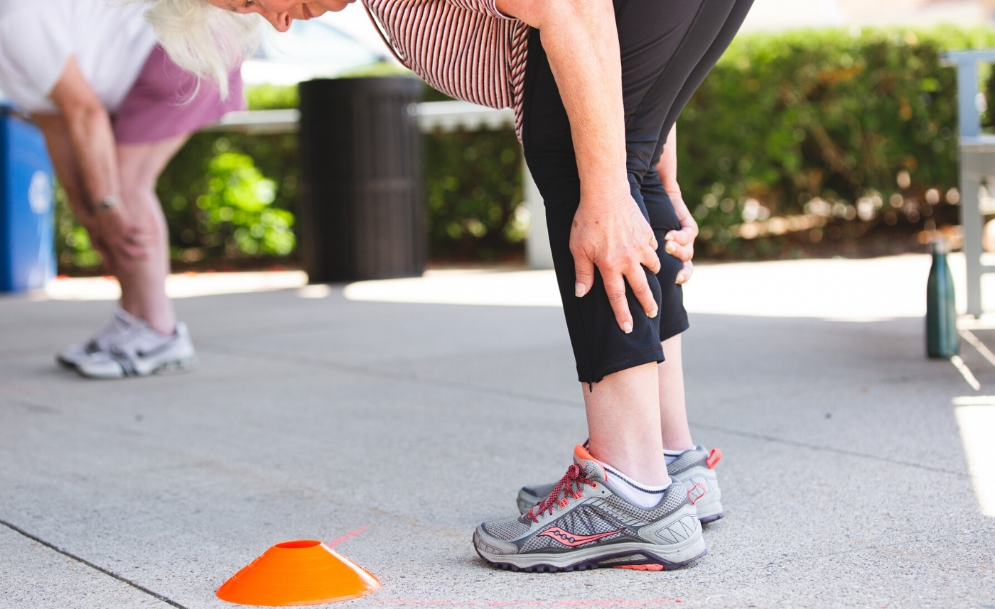 women bending over and stretching