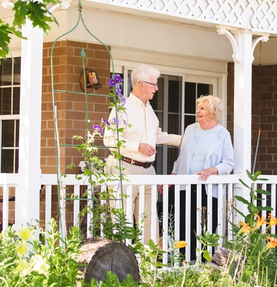 couple on porch of town home laughing together