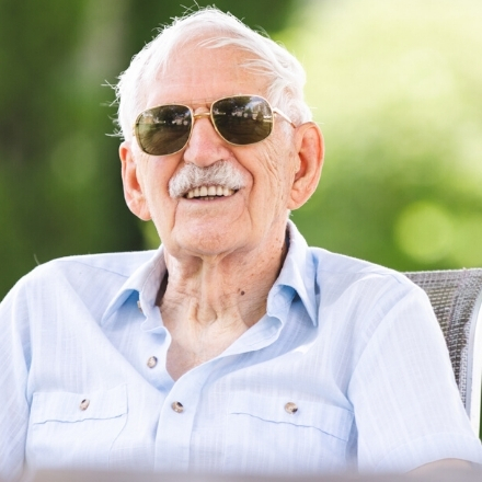 man smiling on sunny day with sunglasses on