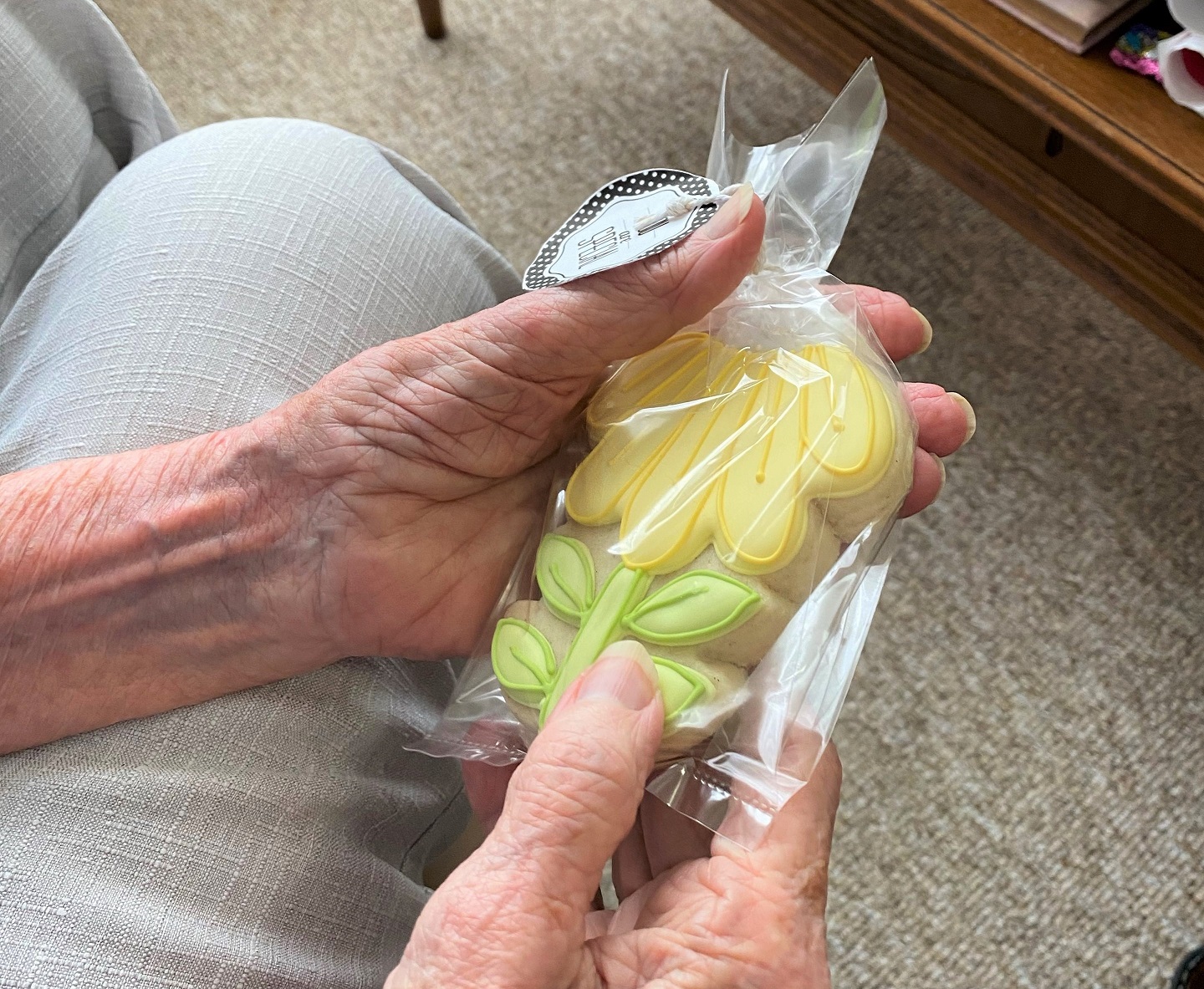 a resident holding a beautiful homemade cookie she received on Mother's Day 