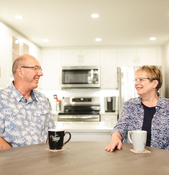 Couple in a life lease at Luther Village on the Park smiling at each other.