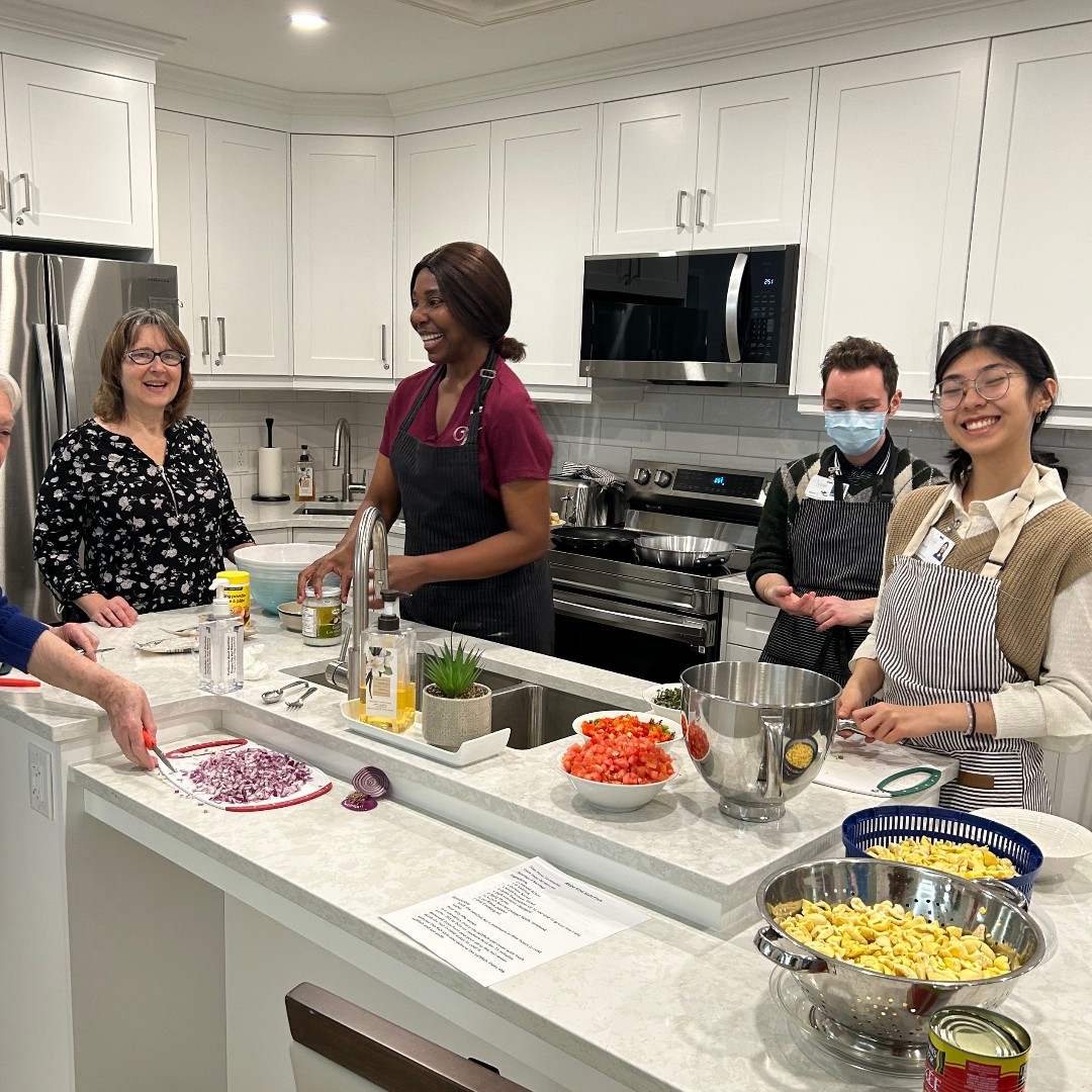Residents and staff eating ational dish of Jamaica, Ackee and Salt Fish with Fried Dumplings, prepared by our own team member.