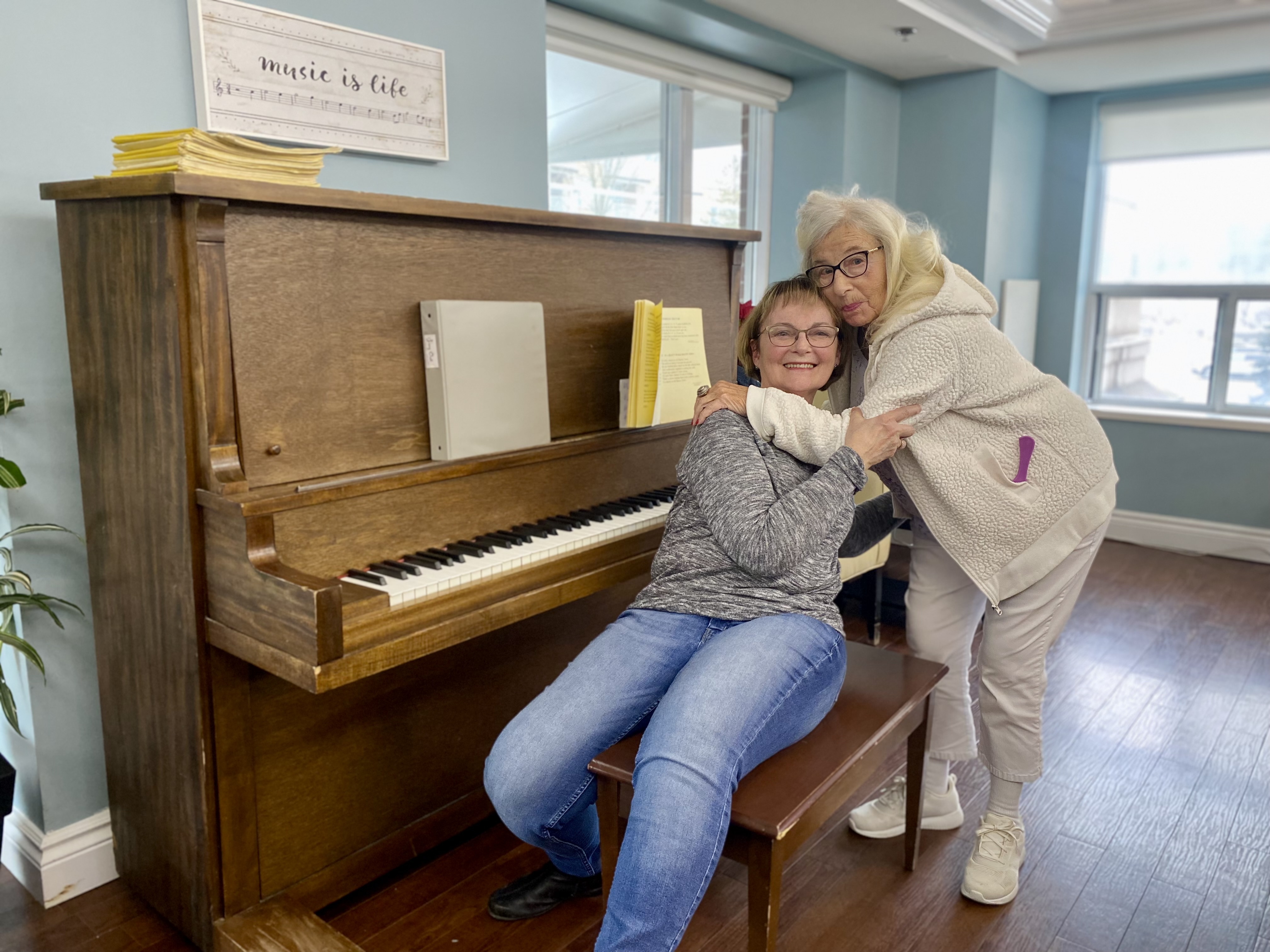 Picture of two people standing by the piano at Luther Village on the Park.