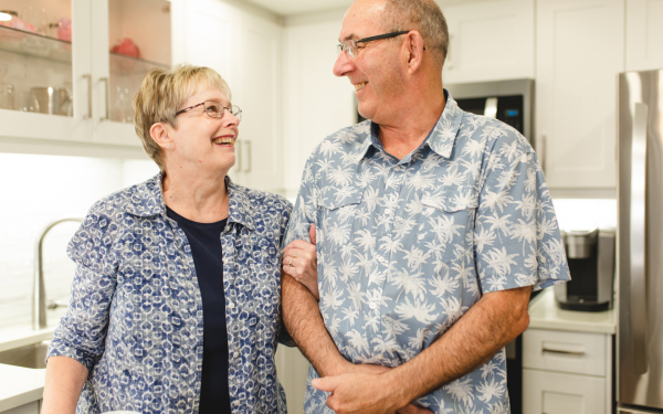 Couple holding hands laughing together.