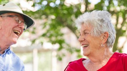 couple laughing looking at eachother 