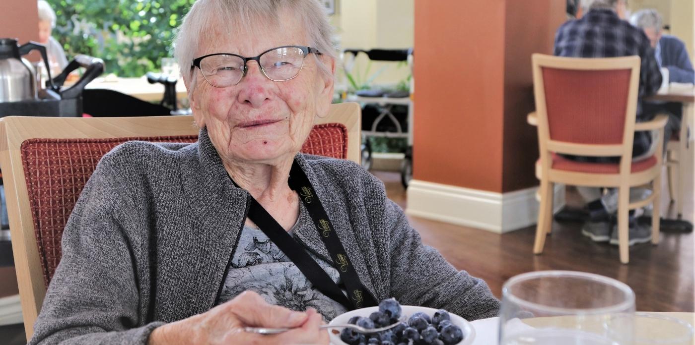 women smiling while eating blue berries